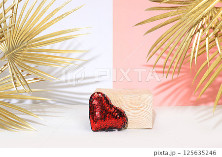 Minimal abstract background for cosmetic products presentation.Empty premium podium with shadows of tropical palm leaves on beige wall,template for design,pedistal display podium,selective focus 125635246
