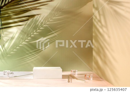 Premium empty podium with shadows and ice cubes on sunny elegant background,summer party concept,minimal abstract background for cosmetic products presentation,design template,podium on 125635407