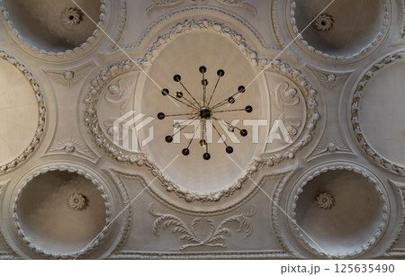 Look up at A stunning chandelier hanging on The ceilings are made of plaster is carved into a dome shape. Look up at A stunning chandelier hanging on The ceilings are made of plaster is carved into a dome shape. 125635490