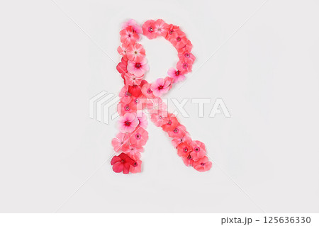 A letter R made from real fresh flowers. Creative floral font concept. Unique collection of letters and numbers for design. Spring, summer, autumn and valentines, creative idea, selective focus 125636330