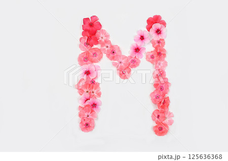 Letter M made from real fresh flowers. Creative floral font concept. Unique collection of letters and numbers for design. Spring, summer, autumn and valentines, creative idea 125636368