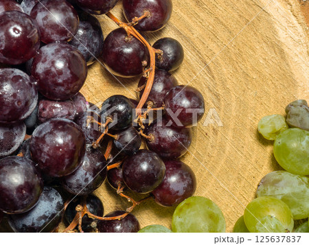 Grapes kishmish on a wooden background. The grapes are overripe. Harvest in the village 125637837