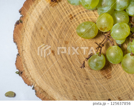 Grapes kishmish on a wooden background. The grapes are overripe. Harvest in the village. Grapes kishmish on a wooden background. The grapes are overripe. Harvest in the village. 125637856
