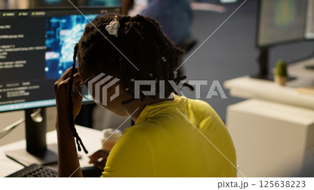Staff member in office yawning during shift, feeling tired while looking at artificial intelligence software on PC. Exhausted african american AI company employee being sleepy in workspace, camera A Staff member in office yawning during shift, feeling tired while looking at artificial intelligence software on PC. Exhausted african american AI company employee being sleepy in workspace, camera A 125638223