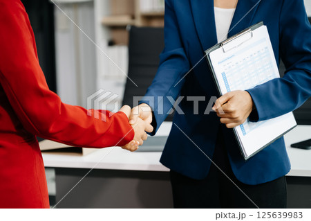 Two confident business man shaking hands during a meeting in the office, success, dealing, greeting and partner Two confident business man shaking hands during a meeting in the office, success, dealing, greeting and partner 125639983