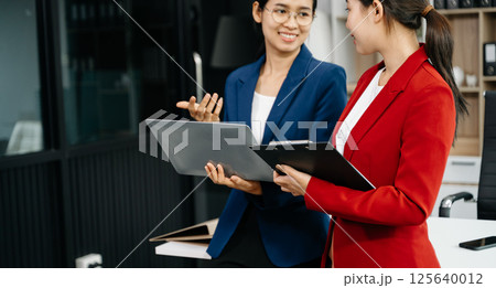 Kind leader executive manager share and discuss business solutions plan ideas on tablet with Asian female marketing manager Kind leader executive manager share and discuss business solutions plan ideas on tablet with Asian female marketing manager 125640012