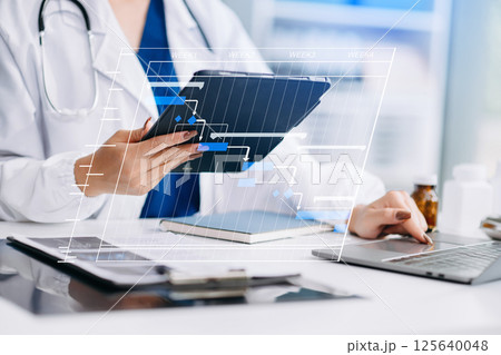 Project manager working and update tasks with Gantt chart scheduling diagram at hospital .success smart medical doctor working with smart medical doctor Project manager working and update tasks with Gantt chart scheduling diagram at hospital .success smart medical doctor working with smart medical doctor 125640048