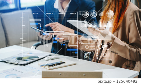 Business team hand Project manager working and update tasks and Gantt chart scheduling virtual diagram. 125640492