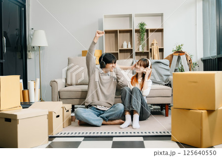 Happy asian young attractive couple man and woman with big boxes moving into a new house, new apartment for couple 125640550