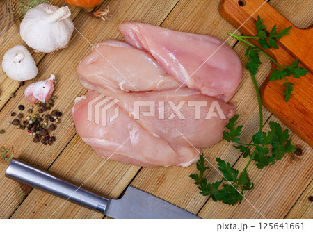Raw chicken breast fillet on wooden surface, nobody 125641661