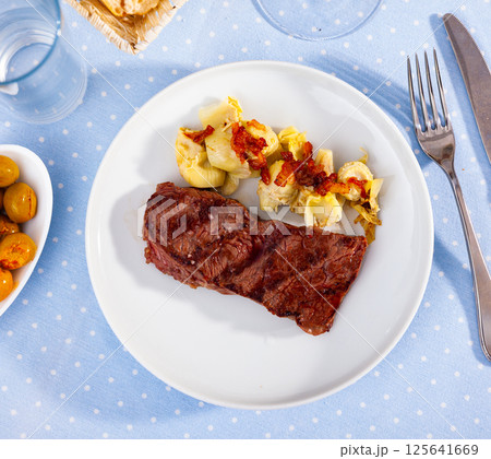 Grilled veal steak with artichokes, healthy dinner 125641669