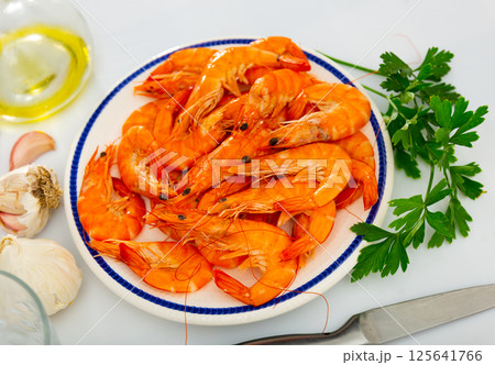 Dish of Spanish cuisine - baked in oven langoustine served with lemon 125641766