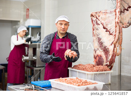 Adult man preparing minced meat in container 125641857