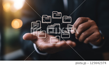 Business Professional Managing Digital Documents with Floating Folder Icons in Modern Office Setting Business Professional Managing Digital Documents with Floating Folder Icons in Modern Office Setting 125642374