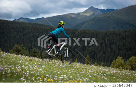 Riding mountain bike on beautiful forest mountain top 125643347