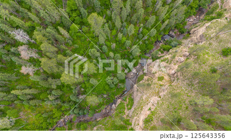 Drone view above people sliding in the Devils Bathtub waterfall and pool in Spearfish Canyon, South Dakota 125643356