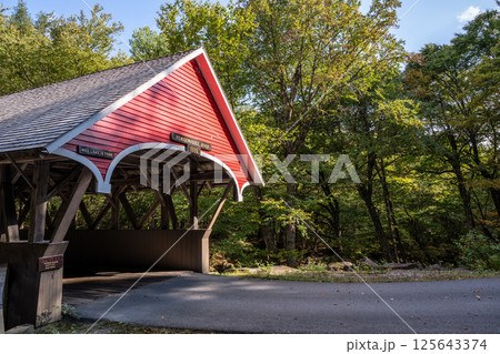 Flume Covered Bridge in New Hampshire's Franconia Notch State Park spanning the Pemigewasset River. 125643374