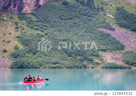 Tourists using a rented canoe in Lake Louise, Alberta, Canada  125643532