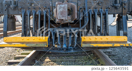 Track level view of the front grill and blade of a locomotive train. Track level view of the front grill and blade of a locomotive train. 125643591