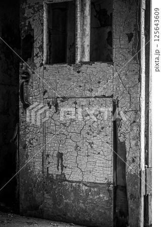 Chipped and peeling lead based paint on an old wall. 125643609