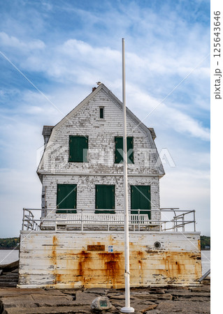 Rockland Breakwater Lighthouse cutting through the harbor on the Gulf of Maine  125643646
