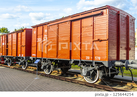 Red orange vintage retro train steam locomotive wooden wagon Belarus. 125644254