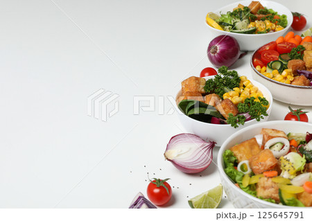 Fried tofu salad with vegetables on a light background 125645791