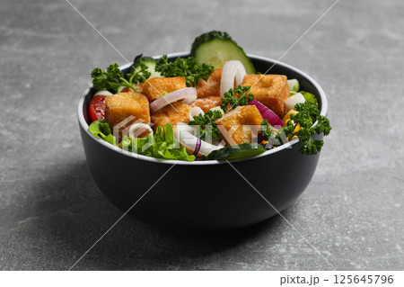 Fried tofu salad in a bowl close-up 125645796