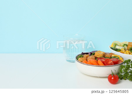 Fried tofu salad with fresh vegetables on a white table 125645805
