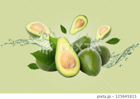 Healthy food, Avocados, leaves and water on light green background Healthy food, Avocados, leaves and water on light green background 125645813