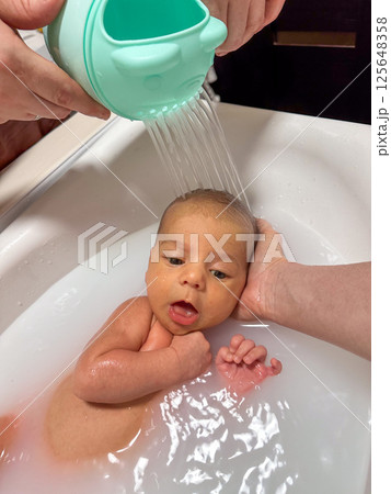 Newborn Baby Bathtime in little bath Newborn Baby Bathtime in little bath 125648358