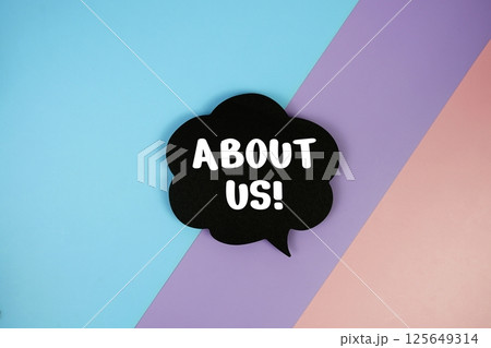 About Us text on speech bubble top view on blue, purple and pink geometric background 125649314