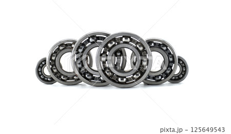 Several ball bearings neatly arranged in front of a white background, ready for use. 125649543