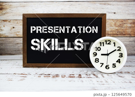 Presentation Skills text message and alarm clock on wooden background 125649570