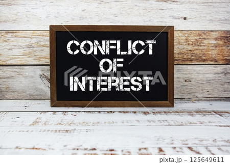 Conflict Of Interest typography text on wooden blackboard Conflict Of Interest typography text on wooden blackboard 125649611