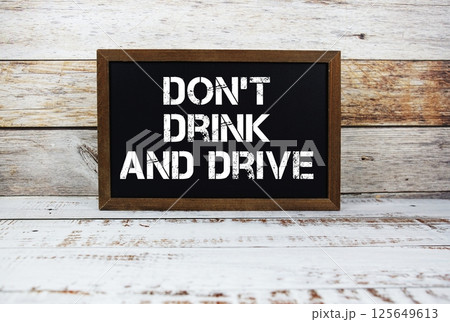 Don't Drink And Drive typography text on wooden blackboard Don't Drink And Drive typography text on wooden blackboard 125649613