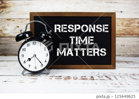 Response Time Matters text message and alarm clock on wooden background 125649625