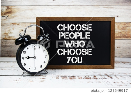 Choose People Who Choose You text message and alarm clock on wooden background Choose People Who Choose You text message and alarm clock on wooden background 125649917