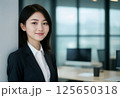 オフィス環境で微笑むアジア系ビジネスウーマン 125650318