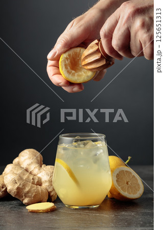Ginger Ale with ice and lemon on a black background. Ginger Ale with ice and lemon on a black background. 125651313