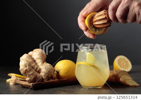 Ginger Ale with ice and lemon on a black background. Ginger Ale with ice and lemon on a black background. 125651314