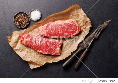 Raw marbled striploin steak, fresh, rich, ready for cooking Raw marbled striploin steak, fresh, rich, ready for cooking 125651492