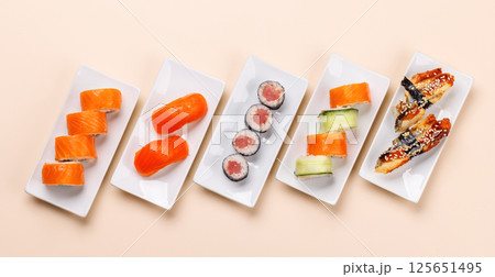 Assorted sushi and maki rolls beautifully arranged on plates Assorted sushi and maki rolls beautifully arranged on plates 125651495