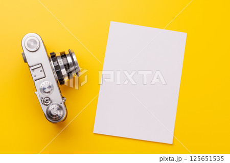 Travel-themed flat lay with blank photo card, camera Travel-themed flat lay with blank photo card, camera 125651535