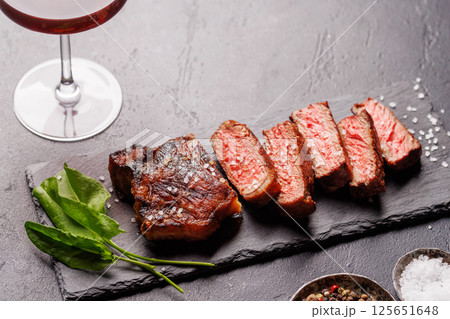 A perfectly cooked sliced striploin steak with a juicy, tender texture 125651648