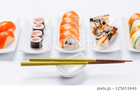 Assorted sushi and maki rolls beautifully arranged on plates 125651649