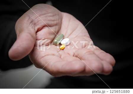 Hand Holding Daily Medications 125651880
