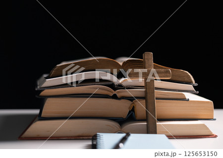 Old library, an open Bible lay on the table, its holy pages of scripture illuminated in the dark room. bible, holy, dark, old, open, library, pages, scripture, table, book, page. Old library, an open Bible lay on the table, its holy pages of scripture illuminated in the dark room. bible, holy, dark, old, open, library, pages, scripture, table, book, page. 125653150