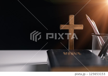 Old library, an open Bible lay on the table, its holy pages of scripture illuminated in the dark room. bible, holy, dark, old, open, library, pages, scripture, table, book, page. 125653153