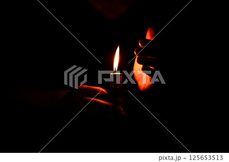 In the church, candle flickered beside cross as Christians gathered to pray, their faith in Jesus and spiritual devotion illuminated by Bible in background, deepening their Catholic worship. In the church, candle flickered beside cross as Christians gathered to pray, their faith in Jesus and spiritual devotion illuminated by Bible in background, deepening their Catholic worship. 125653513